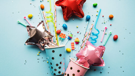 Birthday,Party,Caps,,Paper,Straws,,Candy,And,Baloons,On,Blue