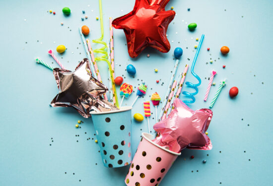 Birthday,Party,Caps,,Paper,Straws,,Candy,And,Baloons,On,Blue