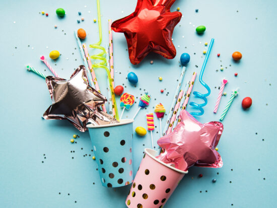 Birthday,Party,Caps,,Paper,Straws,,Candy,And,Baloons,On,Blue